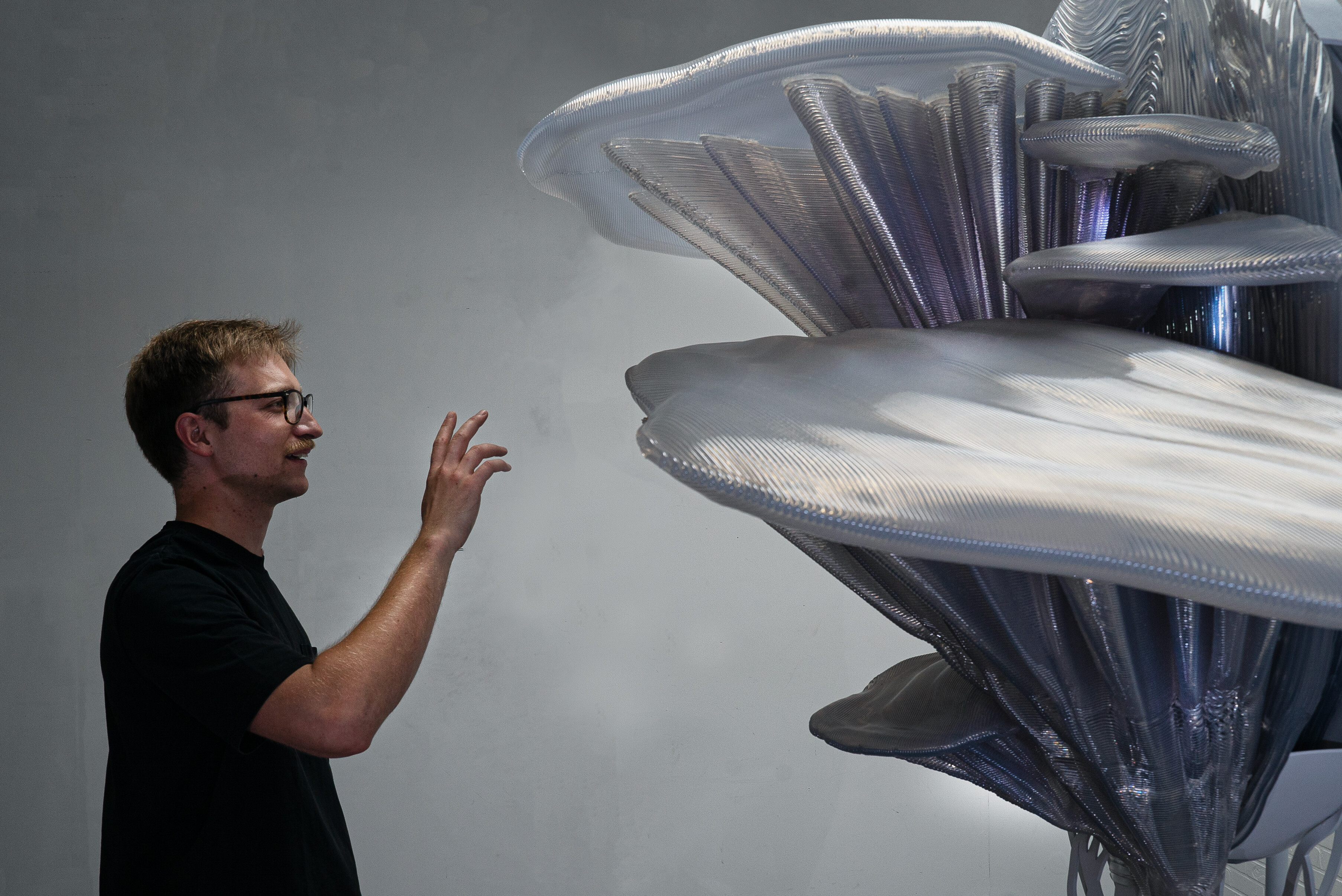 The Annual Meeting of the New Champions 2025 in Tianjin, China, will showcase how art, AI, and ecology intersect, featuring installations from Thijs Biersteker and Ronen Tanchum. Biersteker's "Fungal Faculty" combines AI with ecological themes, using mycelium networks to challenge perceptions of intelligence and sustainability. Tanchum's "Seeds of Tomorrow" employs generative AI and real-time motion tracking to create an interactive experience that explores the relationship between nature and technology. These exhibitions foster dialogue about the evolving dynamics of humanity with ecological and technological advancements.